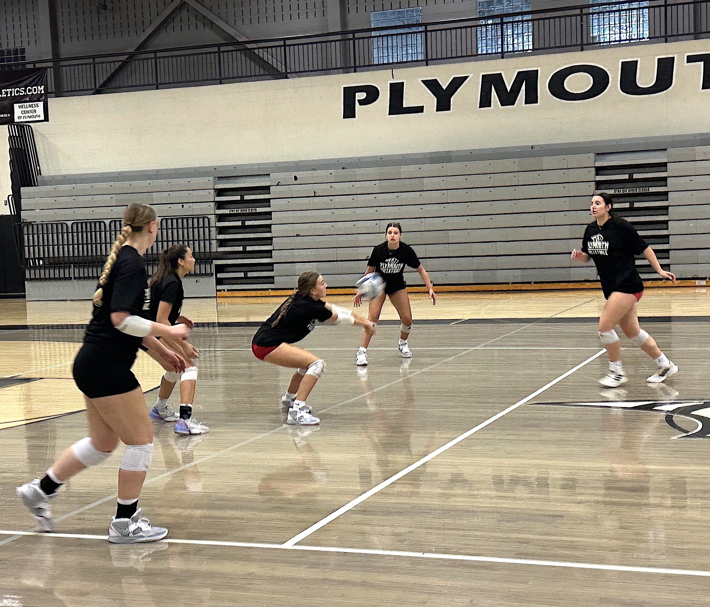 A Plymouth defensive specialist handles a serve Thursday morning