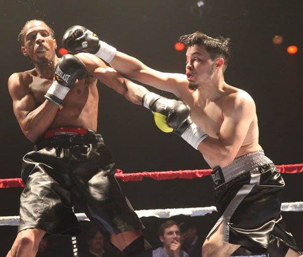 Alejandro Hernandez throws a strong right jab at an opponent during a professional boxing match