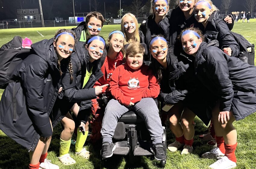 Nathan Miller is surrounded by members of the Canton girls soccer team which dedicated a fundraising game to the soon to be high school freshman
