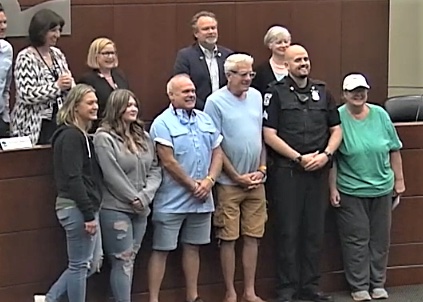 The Canton Township neighbors a member of the Canton Township Public Safety Department and the woman who was rescued from a burning home are pictured during the Aug 22 Board of Trustees meeting